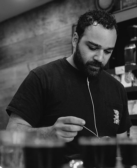 Mazi Razani cupping (tasting) coffee at Blueprint.