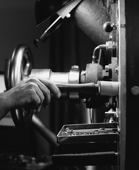 Hands at the ready - Mazi Razani prepares to pull a sample of coffee being roasted using the trier on the Gothot roaster at Blueprint Coffee.