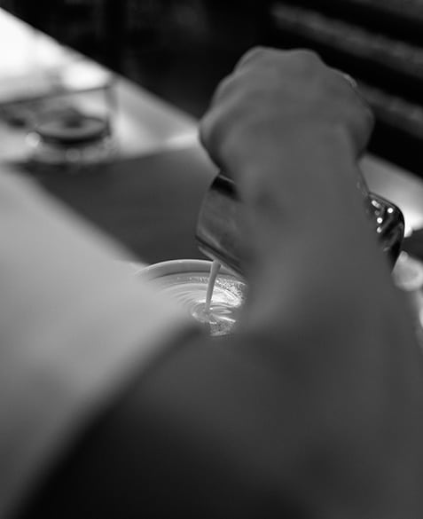 roy brady of blueprint coffee pours a latte
