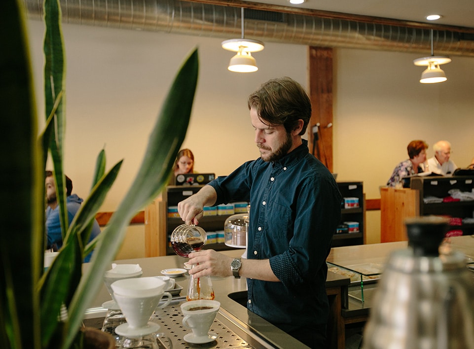 Kevin Reddy finishes a brew on the Blueprint Coffee brew bar.