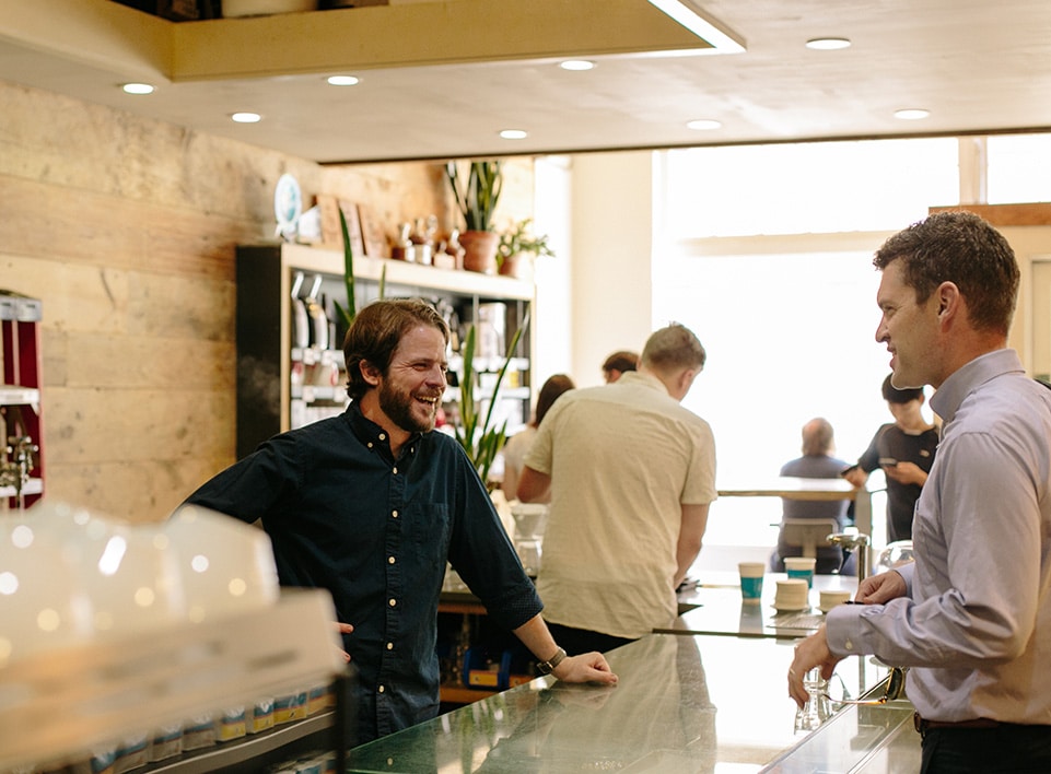 Kevin Reddy chats with a guest at Blueprint Coffee.