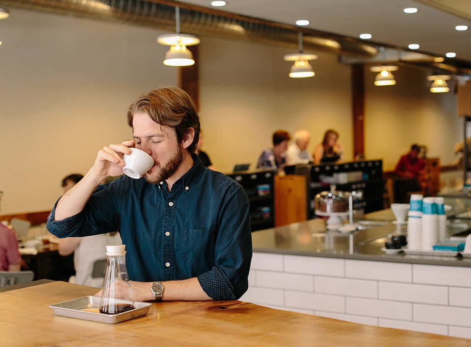 Kevin Reddy takes a moment to enjoy a cup of coffee at Blueprint.
