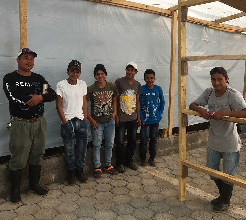 The team at Finca Esperanza poses for a picture inside the new drying house.