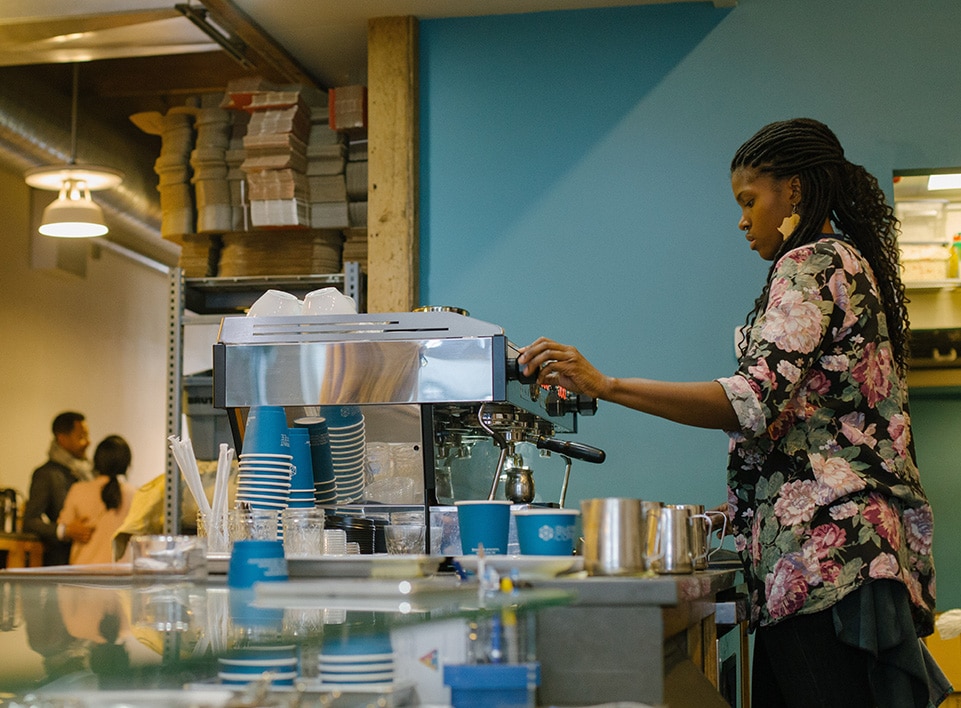 Janelle prepares drinks on the espresso bar at Blueprint Coffee Delmar.