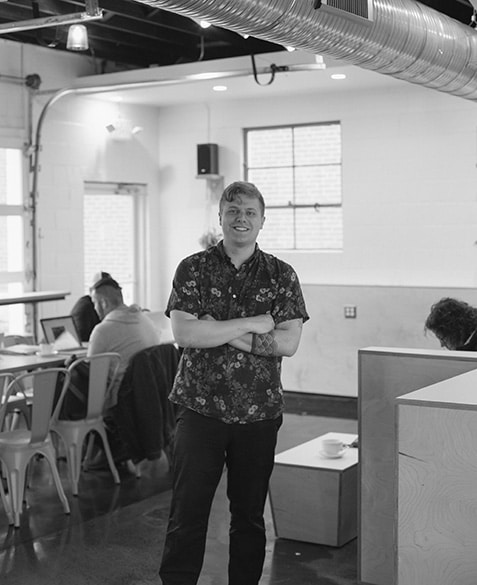 Alex Werth poses for a photo at Blueprint Coffee Watson.