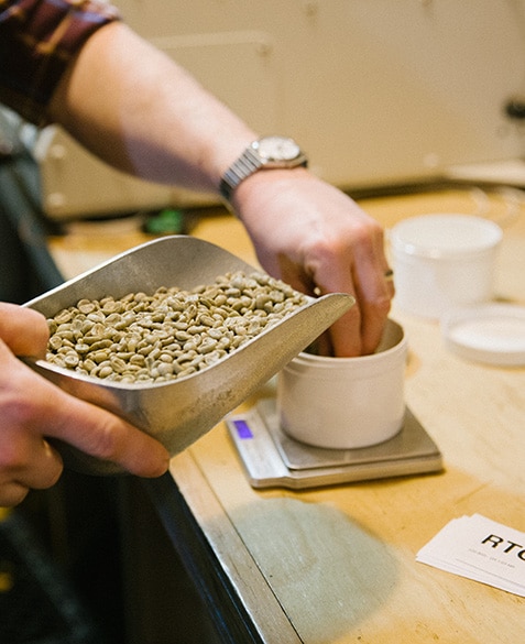 Andrew Timko prepares coffee for sample roasting.