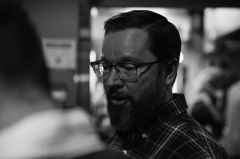 Andrew Timko discusses a sample of coffee while cupping with colleagues. 