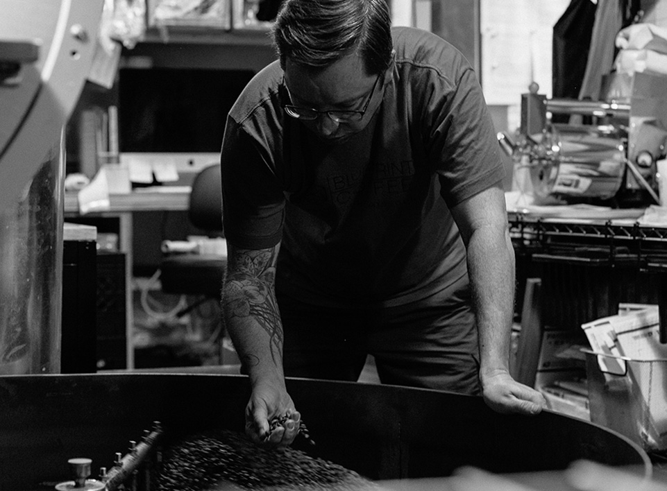 Andrew Timko sorts through coffee that has just left the roaster and is cooling.