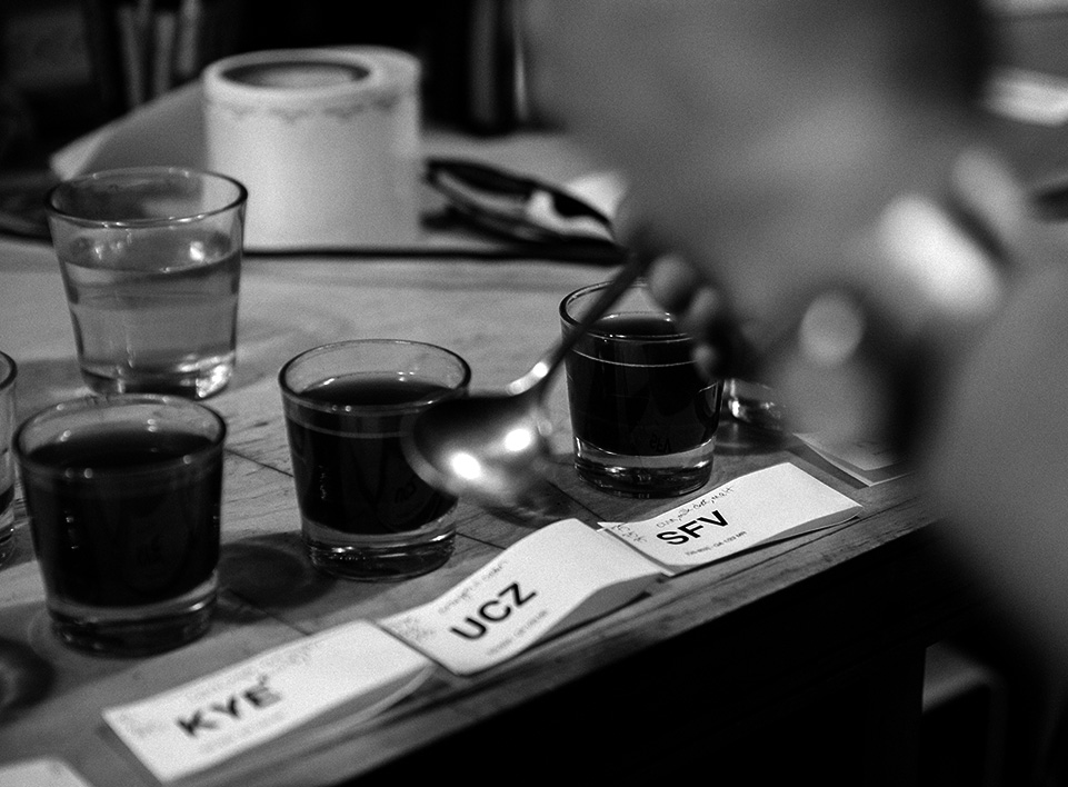 Andrew Timko tastes through sample roasts from an importer.