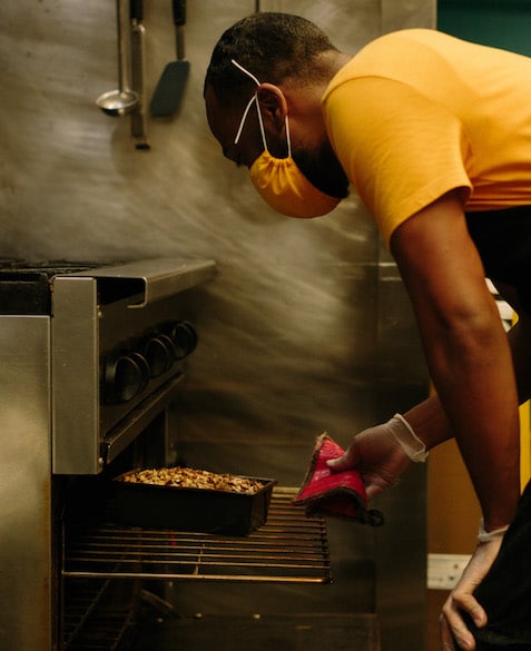 El Strickland takes freshly baked banana bread out of the oven