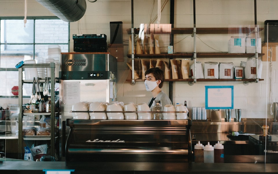 MG Batts working behind the coffee bar at Blueprint Coffee Watson