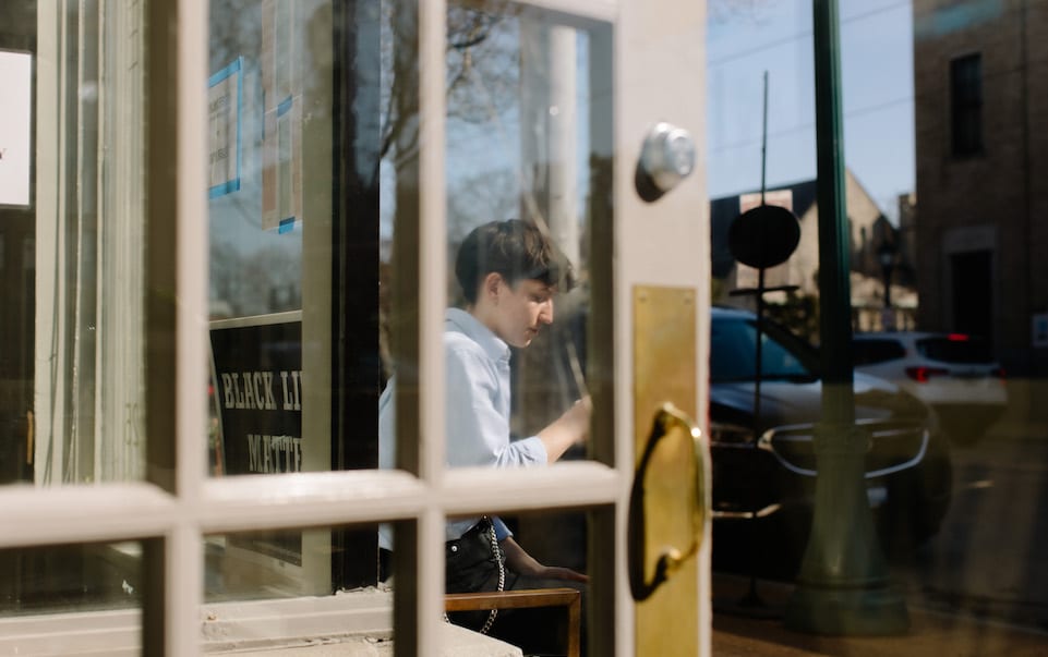 Mac sits outside Blueprint Coffee Delmar