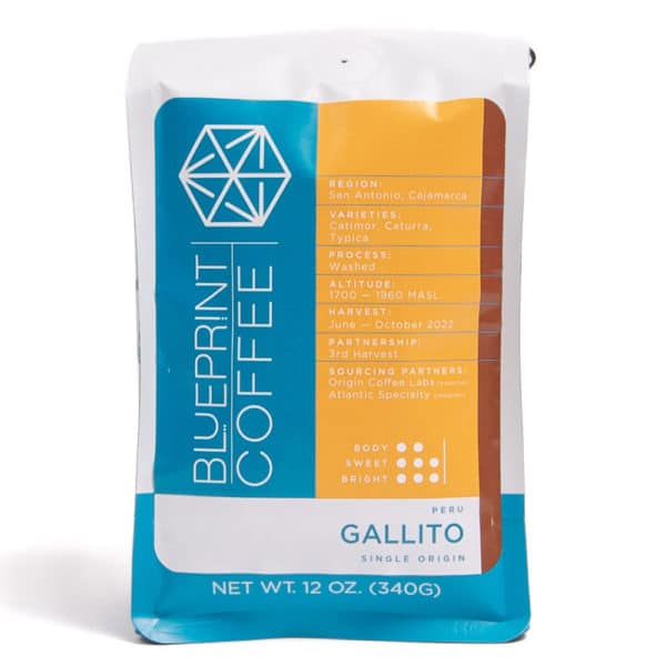 A 12-ounce bag of Gallito, Peru coffee beans. The bag is a blue and white Blueprint Coffee branded package. The label contains text about the coffee along with brown and yellow highlights.